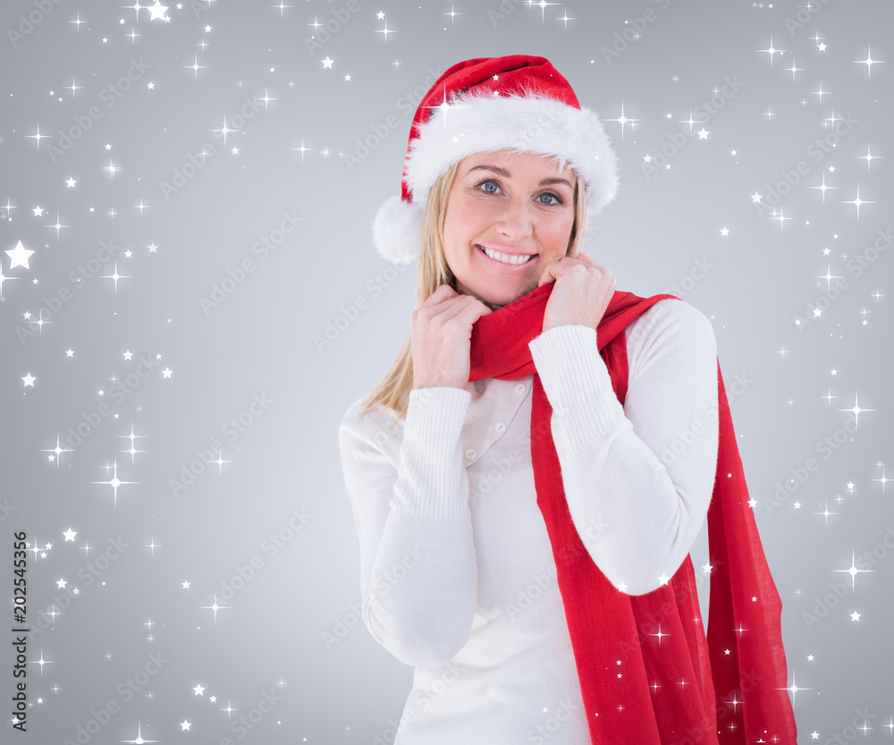 Festive blonde smiling at camera against grey vignette Festive blonde smiling at camera against grey vignette