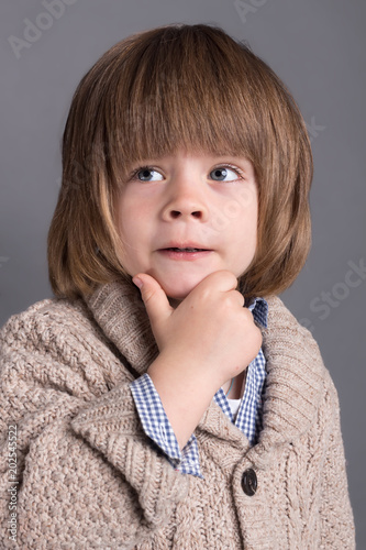 Close-up portrait of funny little boy four years old with a comic expression photo