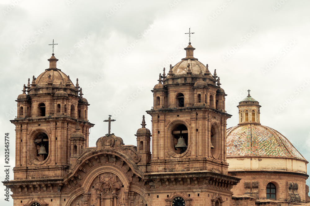 Bell towers and dome of the Temple of the Company of Jesus in Cusco (Peru) in front of the main square