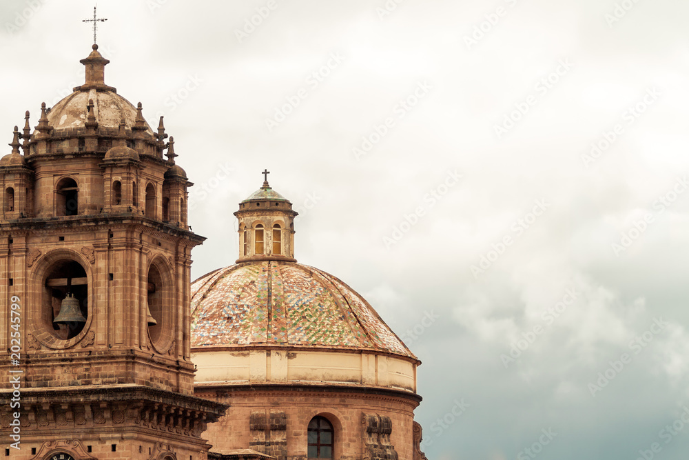 Bell tower and dome of the Temple of the Company of Jesus in Cusco (Peru) in front of the main square