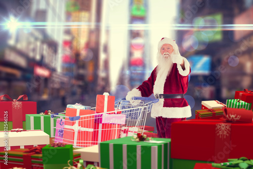 Santa delivering gifts from cart against blurred new york street