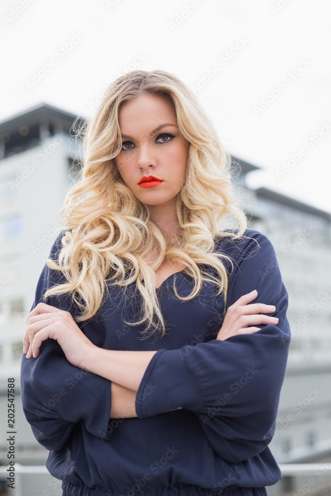 Fototapeta premium Serious gorgeous blonde with red lips posing outdoors