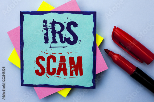 Writing note showing  Irs Scam. Business photo showcasing Warning Scam Fraud Tax Pishing Spam Money Revenue Alert Scheme written on Sticky Note Paper on the Plain background Marker next to it. photo