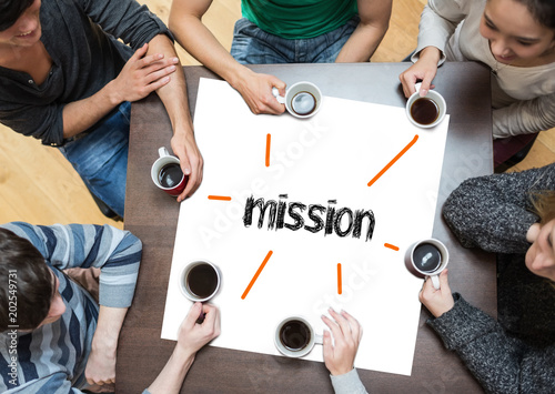 The word mission on page with people sitting around table drinking coffee