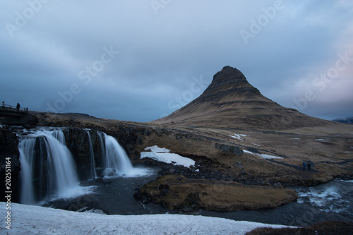 Kirkjufell mountain in Iceland and a cloudy sunset