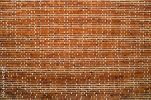 Old realistic brick wall made of red brick in different shads. Red smooth brickwork.