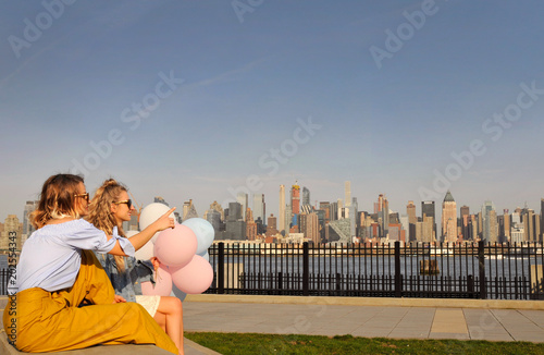 New York city urban women enjoying view of downtown Manhattan skyline, summer travel in USA © Dmytro Flisak
