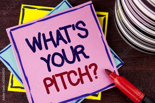 Word writing text What Is Your Pitch Question. Business concept for Present proposal Introducing Project or Product written on Pink Sticky Note paper on wooden background Cup and Marker next to it photo
