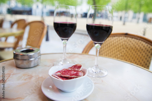 Red wine and sliced salami in Paris, France