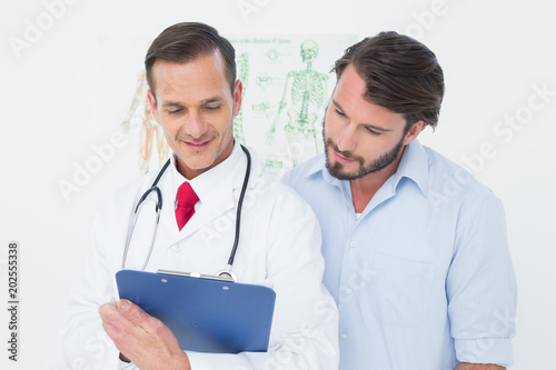 Male doctor discussing reports with patient