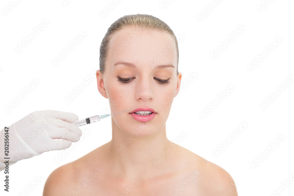Stressed pretty blonde model receiving botox injection