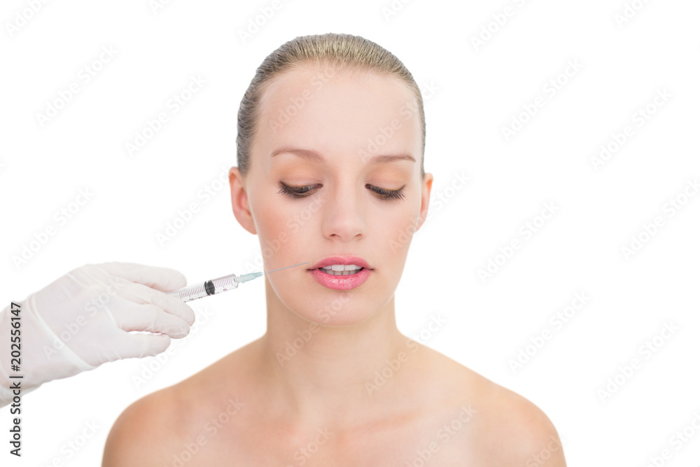 Stressed pretty blonde model receiving botox injection Stressed pretty blonde model receiving botox injection
