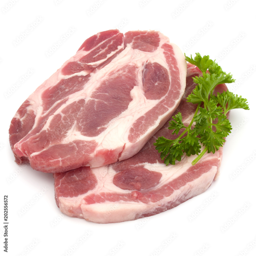 Raw pork neck chop meat with parsley herb leaves garnish isolated on white background cutout Raw pork neck chop meat with parsley herb leaves garnish isolated on white background cutout