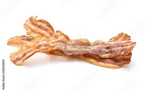 cooked crispy slices of bacon isolated on white background