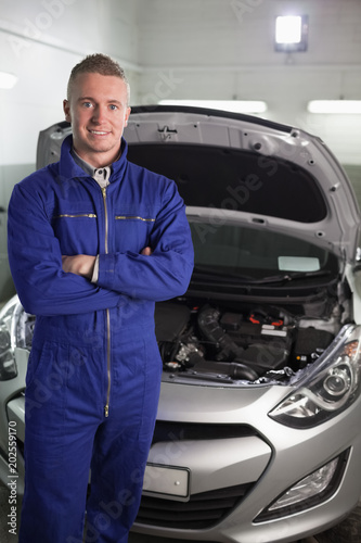 Mechanic standing while looking at camera