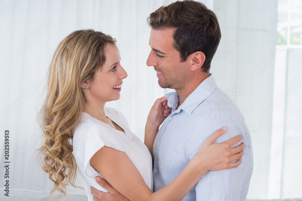 Loving couple looking at each other at home Loving couple looking at each other at home