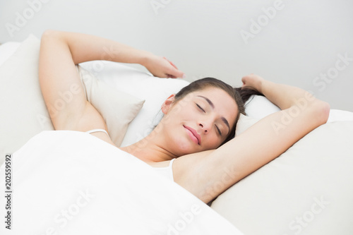 Beautiful woman sleeping in bed with eyes closed