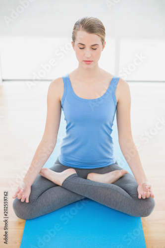 Peaceful pretty blonde relaxing in lotus position