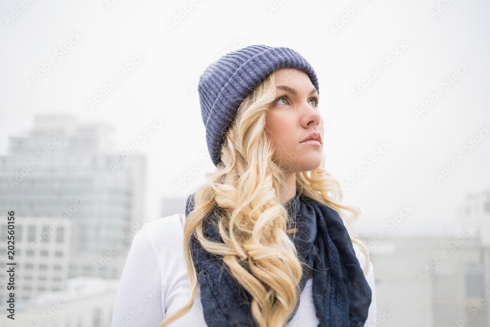 Pensive blonde in winter clothes posing outdoors Pensive blonde in winter clothes posing outdoors