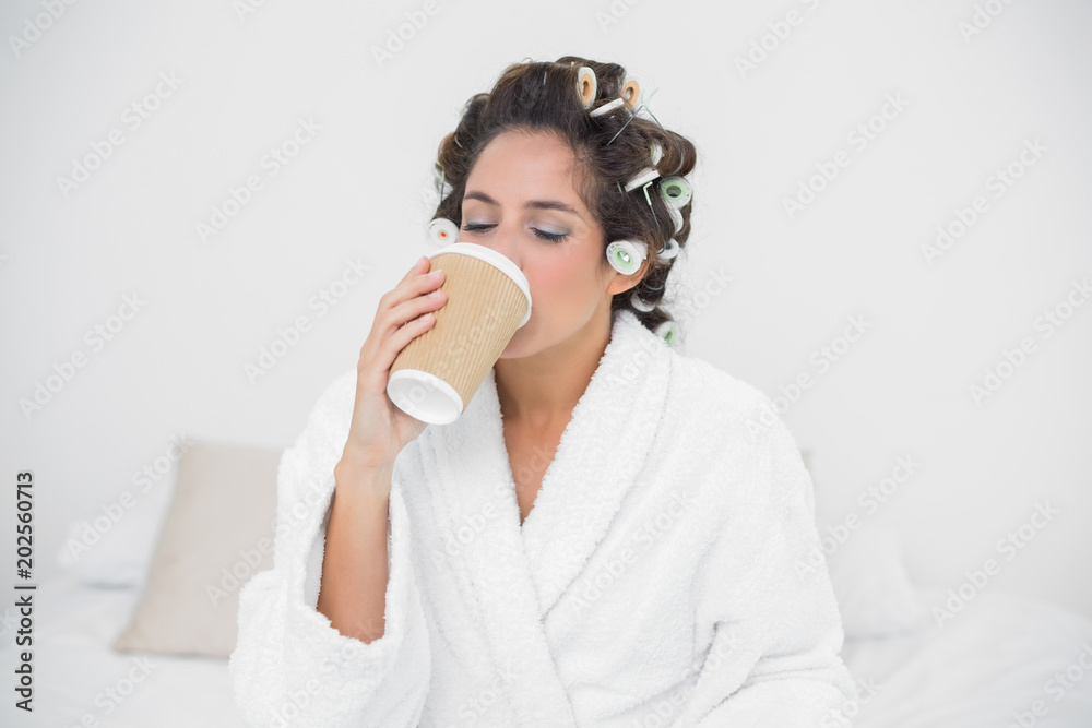 Peaceful natural brunette drinking from disposable cup Peaceful natural brunette drinking from disposable cup