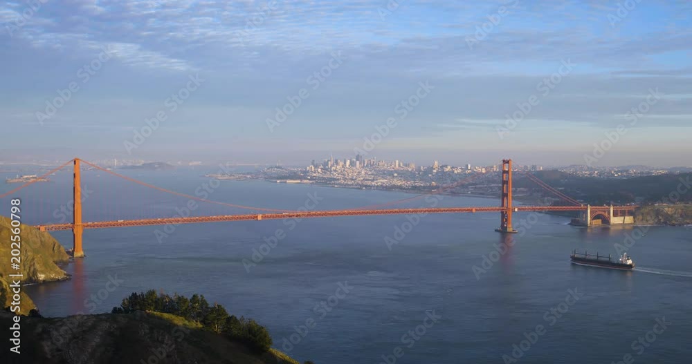 Tanker ship entering San Francisco bay at the Golden Gate bridge with Alcatraz  and cityscape in background wide panoramic scenic landscape 4k DCI video