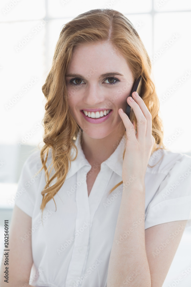 Elegant businesswoman using mobile phone in office Elegant businesswoman using mobile phone in office