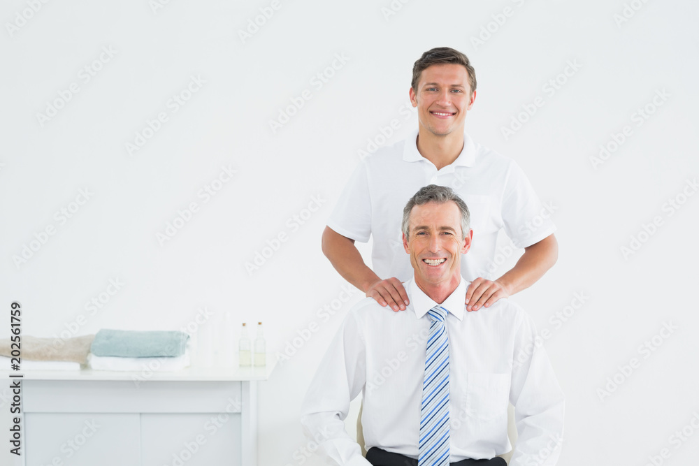 Fototapeta premium Male chiropractor and well dressed mature patient