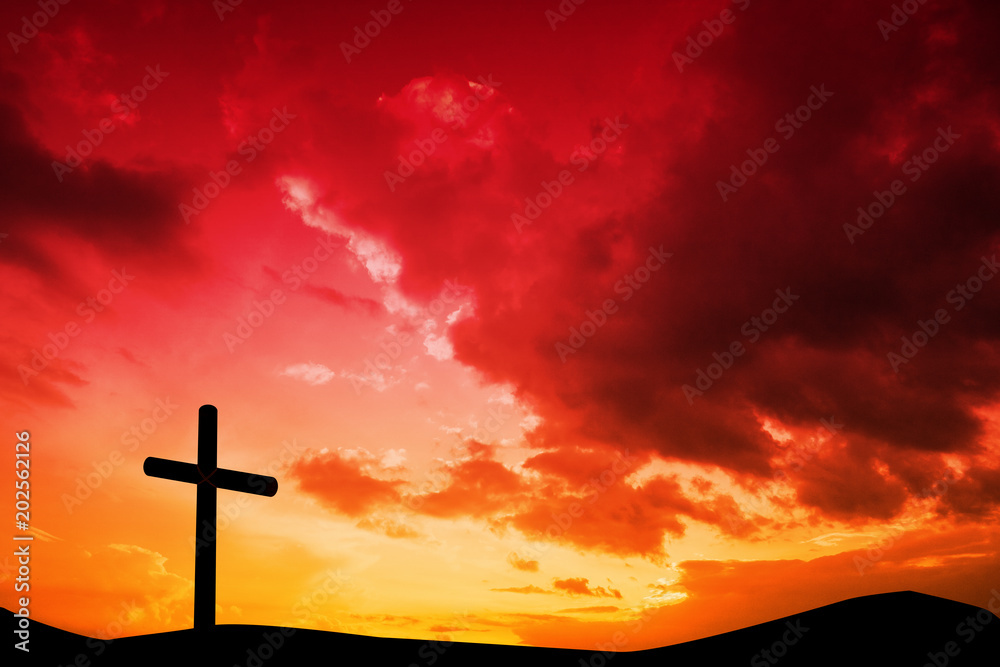 Wooden cross against sky and mountains