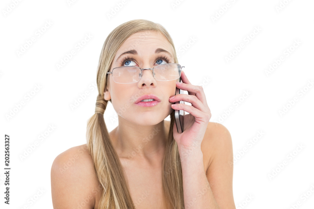 Anxious young blonde woman looking up while calling on phone Anxious young blonde woman looking up while calling on phone