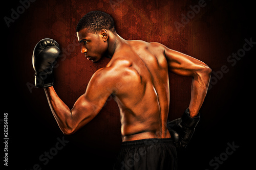 Muscular boxer against dark background © vectorfusionart