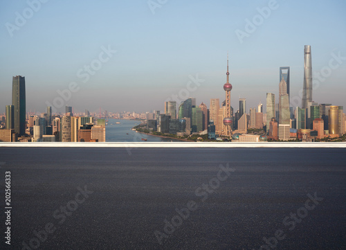 Empty road floor surface with city landmark buildings at Shanghai Skyline