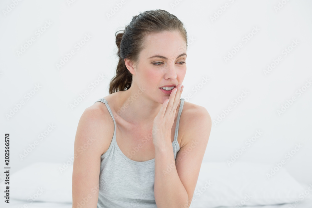 Woman yawning in bed Woman yawning in bed