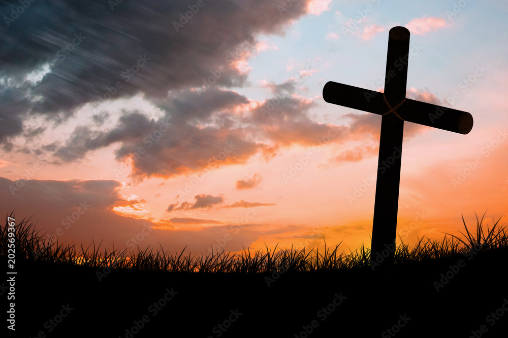 Wooden cross against sun set