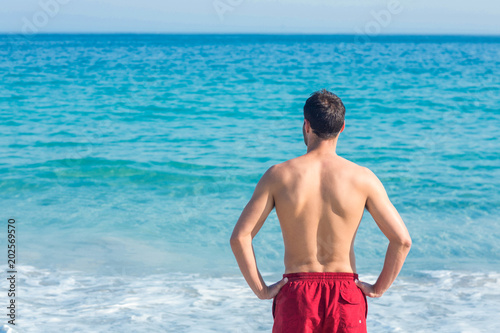 Man looking at the ocean 