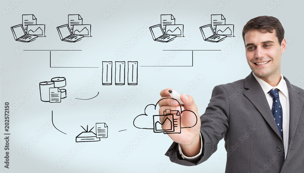 Young businessman writing something against grey vignette Young businessman writing something against grey vignette