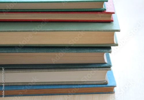 A stack of hardcover books.