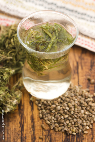 Cannabis herbal tea on wooden background