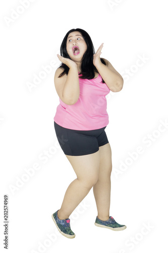 Obese woman with scared expression on studio