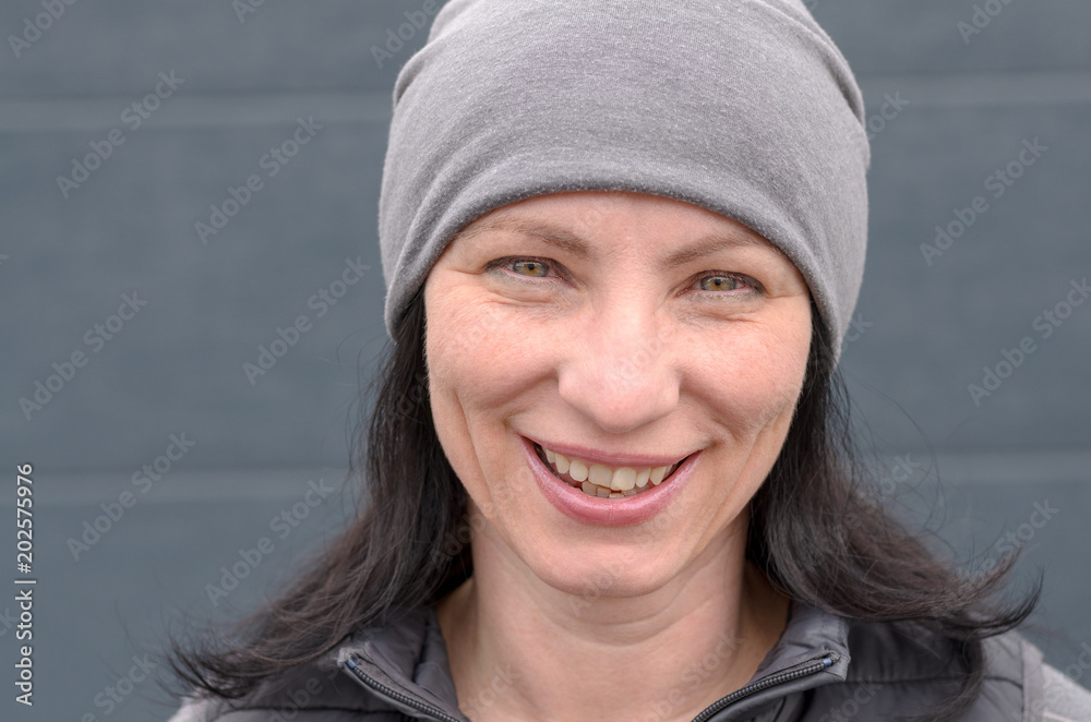 Smiling woman wearing gray beanie hat Smiling woman wearing gray beanie hat