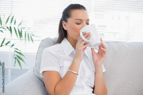 Relaxed attractive woman drinking coffee