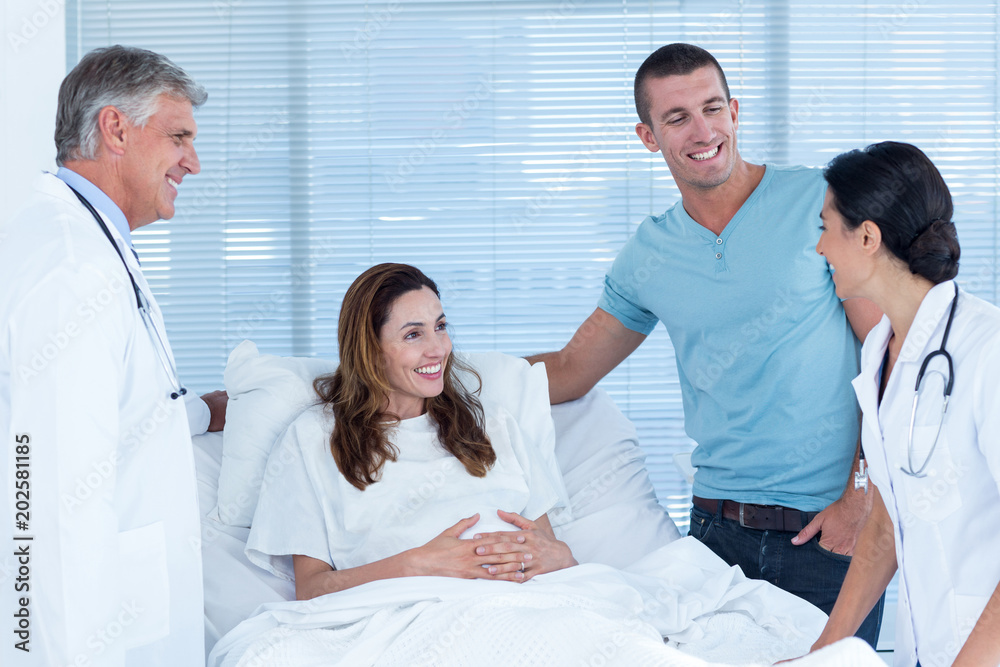 Future parents talking with smiling doctors Future parents talking with smiling doctors