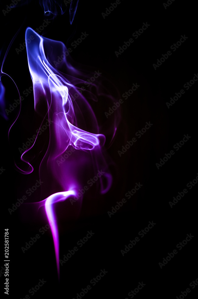 Colorful trickle of smoke on a dark background Colorful trickle of smoke on a dark background
