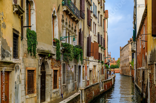 Weathered building facade on a picturesque canal in Venice Italy