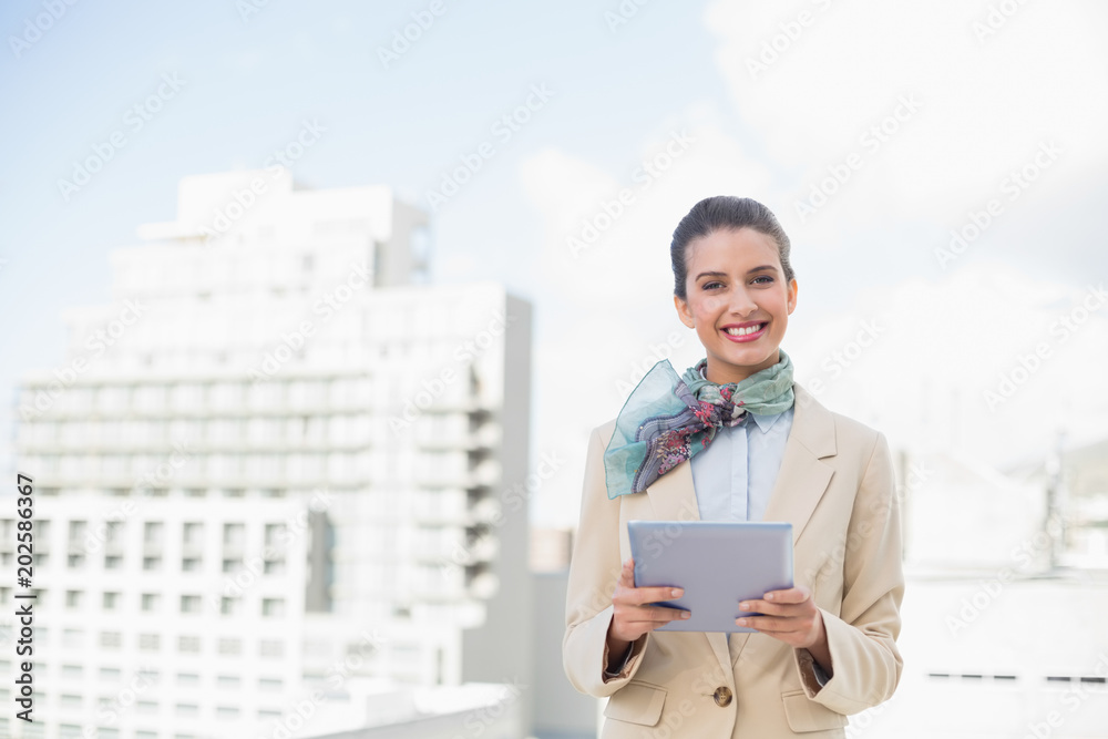 Happy smart brown haired businesswoman using a tablet pc Happy smart brown haired businesswoman using a tablet pc
