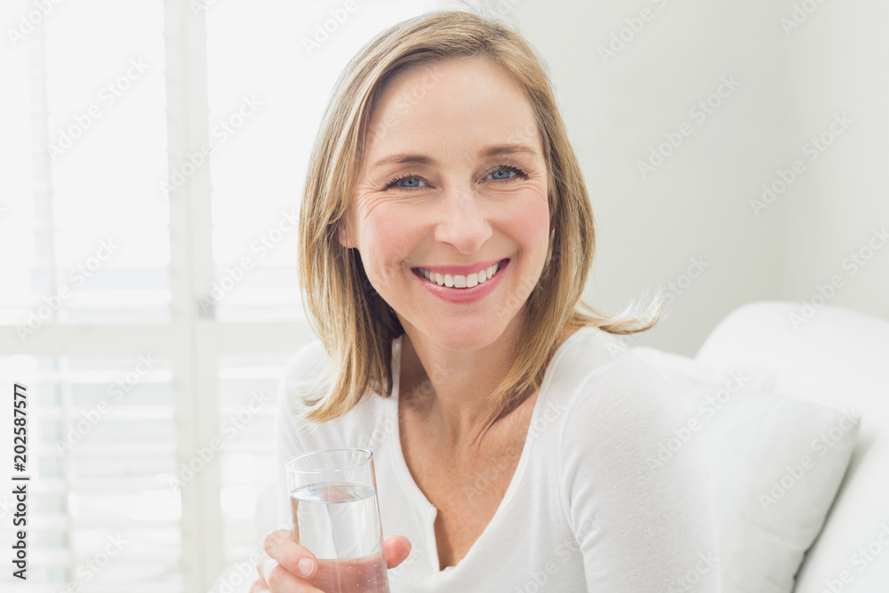 Portrait of a smiling relaxed woman with a glass of water Portrait of a smiling relaxed woman with a glass of water