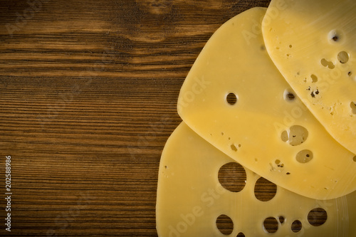 Sliced Cheese Over Rustic Wooden Background