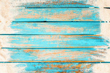 Beach background - top view of beach sand on old wood plank in blue sea paint background. summer vacation concept. vintage color tone.