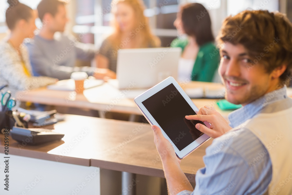 Smiling young man using digital tablet Smiling young man using digital tablet