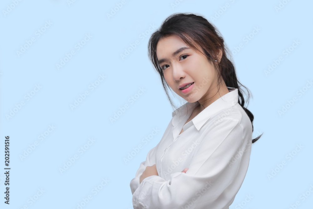 Portrait of attracive young Asian woman posing on blue isolated background. Portrait of attracive young Asian woman posing on blue isolated background.