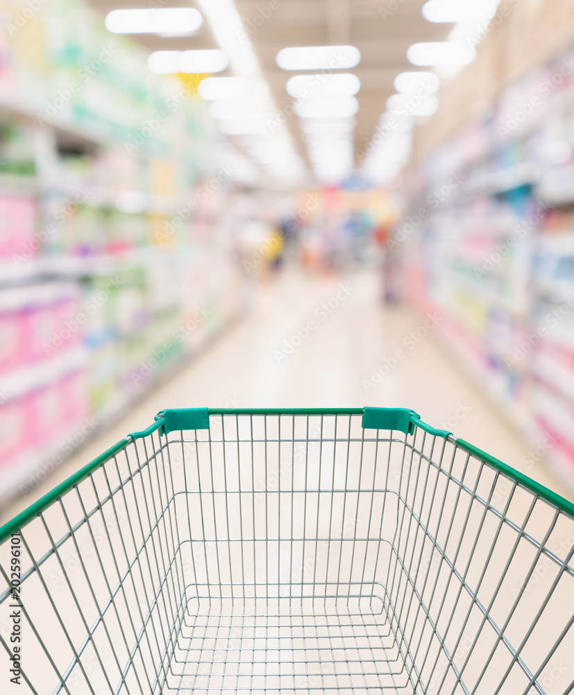Abstract blurred supermarket aisle and shelves with various toilet tissue paper display